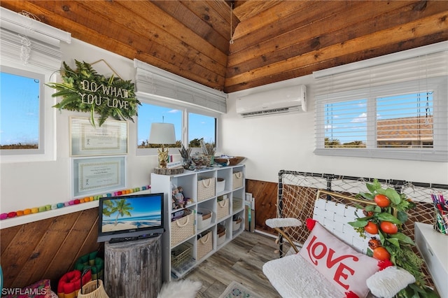 interior space featuring a wall mounted air conditioner, lofted ceiling, and hardwood / wood-style floors