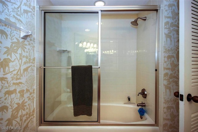 bathroom featuring shower / bath combination with glass door