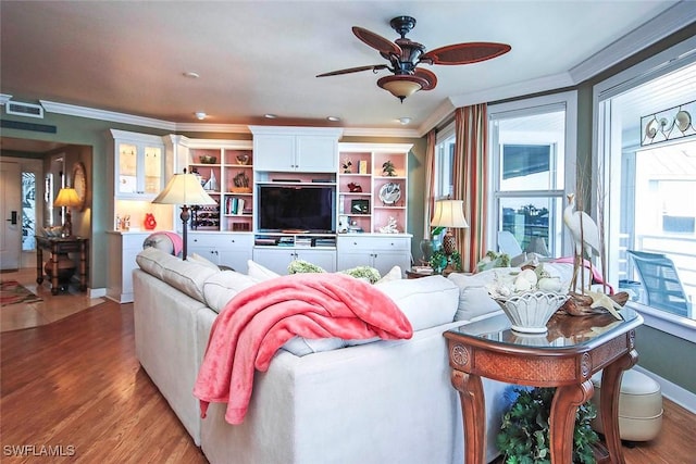 living room featuring crown molding, hardwood / wood-style floors, and ceiling fan