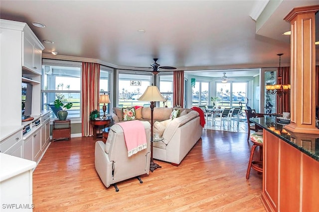 living room with ceiling fan and light hardwood / wood-style floors