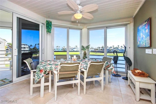 sunroom / solarium with ceiling fan and wooden ceiling