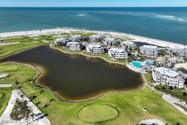 birds eye view of property with a beach view and a water view