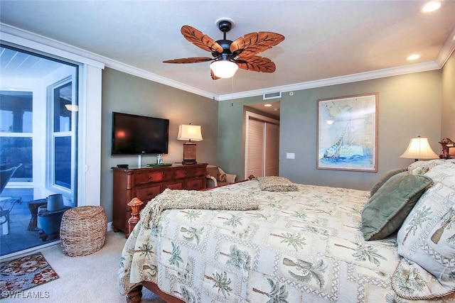 carpeted bedroom featuring a closet, ornamental molding, and ceiling fan