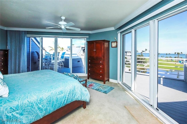 bedroom featuring light carpet, a water view, ceiling fan, access to exterior, and multiple windows