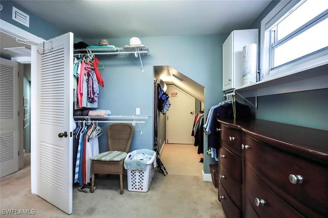 spacious closet featuring light carpet