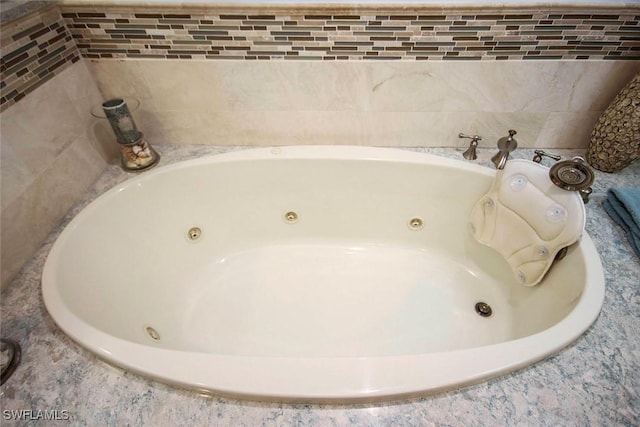 bathroom featuring a relaxing tiled tub