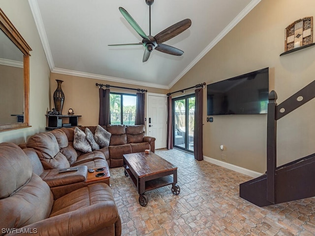 living room with lofted ceiling, stone finish flooring, ornamental molding, and baseboards