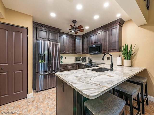 kitchen featuring sink, appliances with stainless steel finishes, light tile patterned floors, and ceiling fan