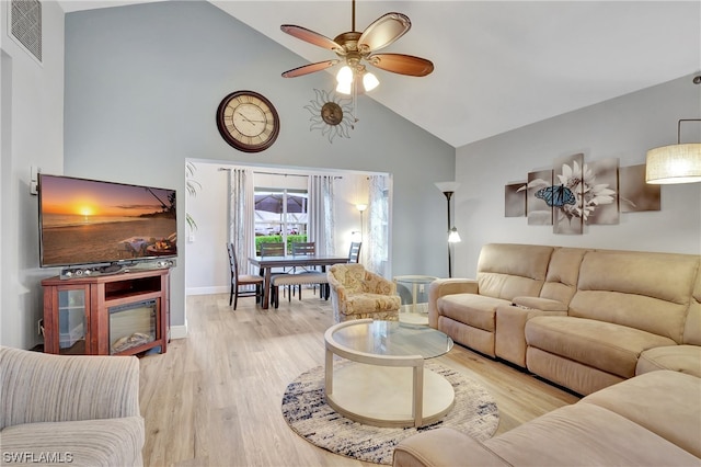 living room featuring high vaulted ceiling, ceiling fan, and light wood-type flooring