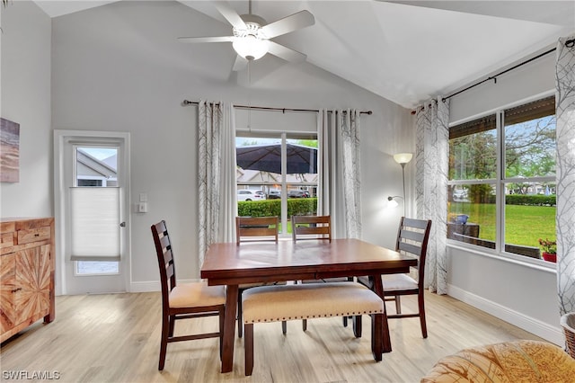 dining space with lofted ceiling, ceiling fan, light wood-type flooring, and a wealth of natural light