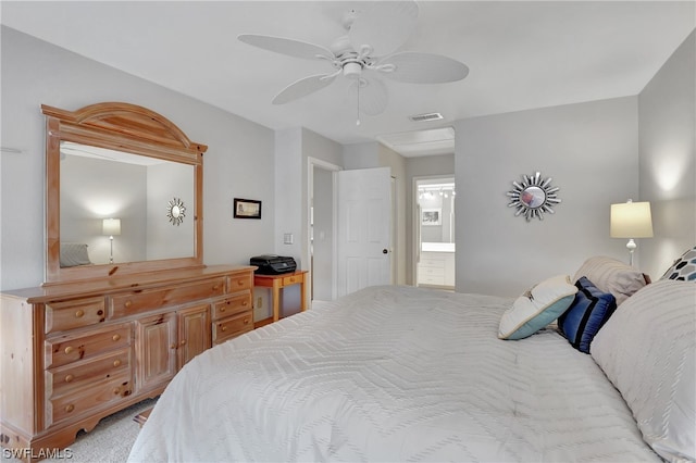 carpeted bedroom featuring connected bathroom and ceiling fan