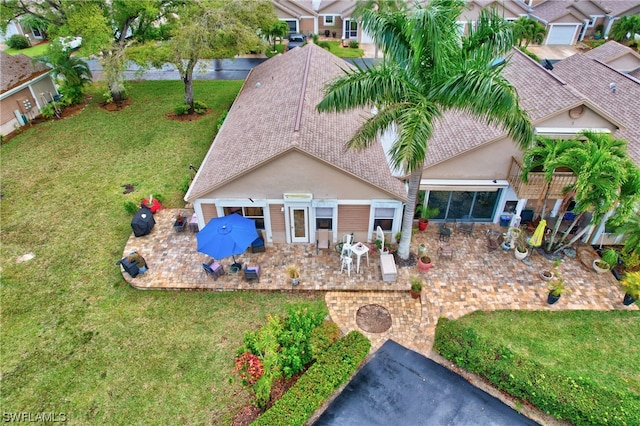 exterior space with a lawn and a patio