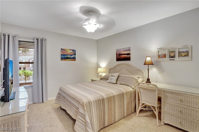 bedroom featuring light carpet and ceiling fan