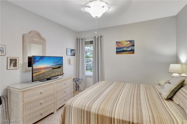 bedroom with light carpet and ceiling fan