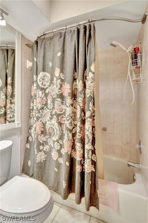 bathroom with shower / bath combo with shower curtain, toilet, and tile flooring