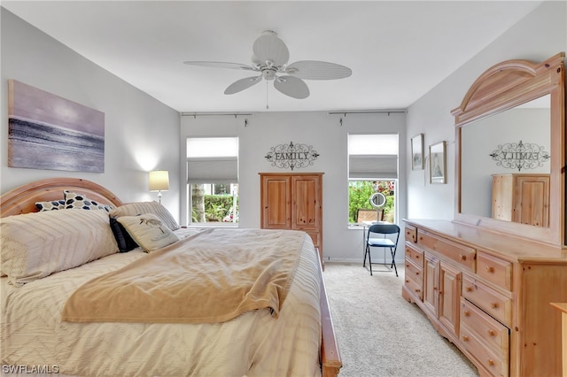 bedroom with light carpet and ceiling fan