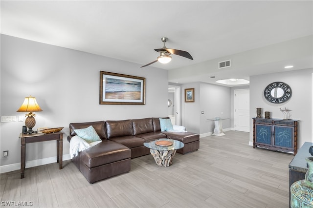 living room featuring light hardwood / wood-style flooring and ceiling fan