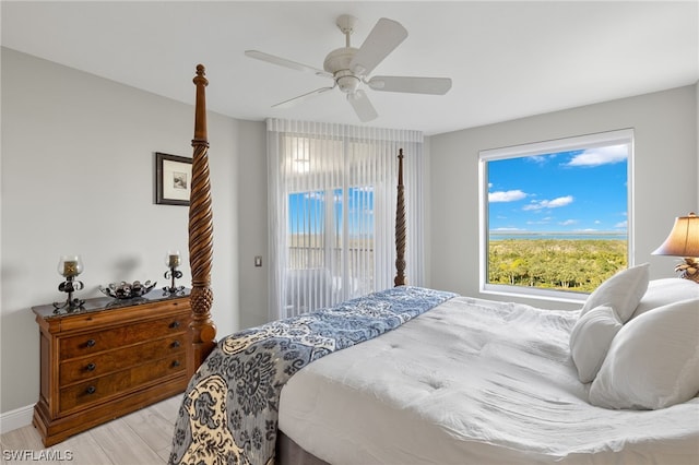 bedroom with access to exterior, light hardwood / wood-style flooring, and ceiling fan