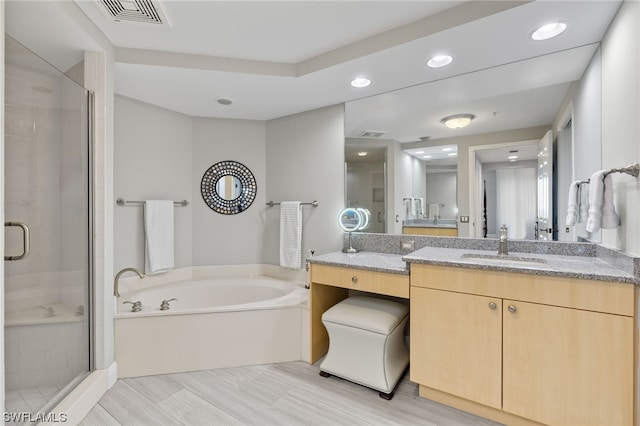 bathroom featuring independent shower and bath and vanity