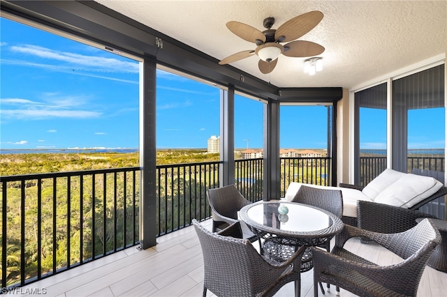 sunroom featuring ceiling fan