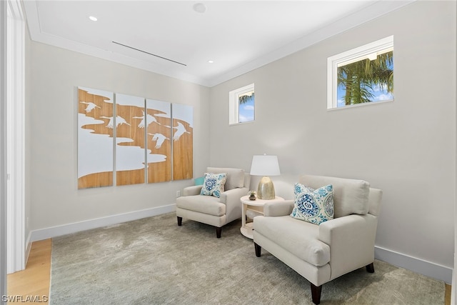 sitting room featuring plenty of natural light, ornamental molding, and light hardwood / wood-style flooring