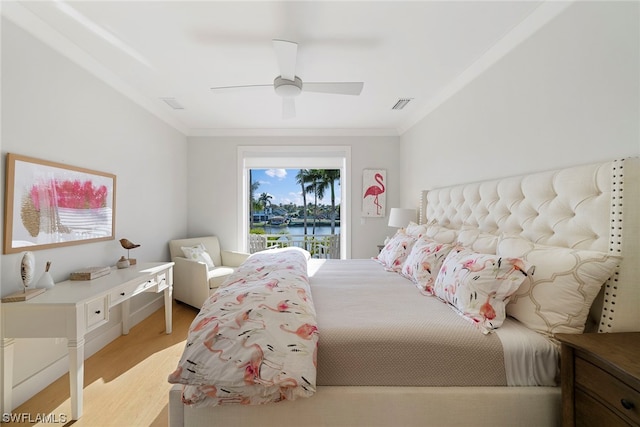 bedroom with access to exterior, ceiling fan, ornamental molding, a water view, and light wood-type flooring