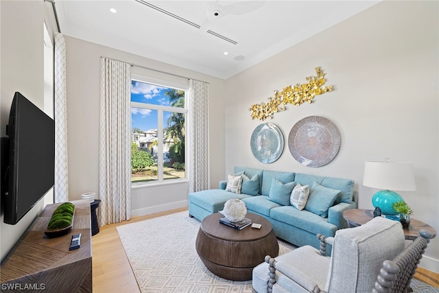 living room featuring light hardwood / wood-style floors and ornamental molding