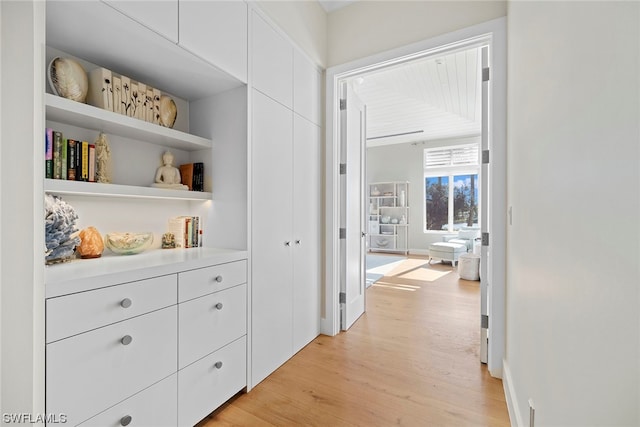 hallway with light hardwood / wood-style flooring