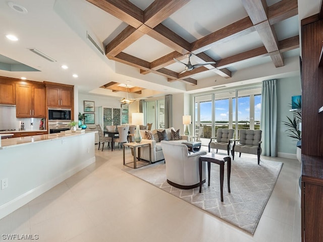 tiled living room with coffered ceiling, a wealth of natural light, ceiling fan, and beamed ceiling