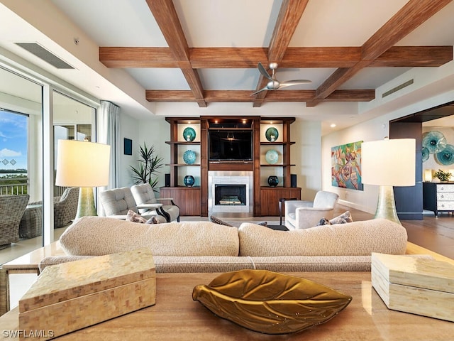 living room with beamed ceiling, coffered ceiling, and a tile fireplace