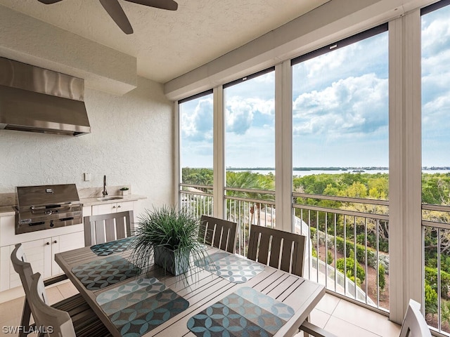 dining area featuring ceiling fan, a textured ceiling, and sink