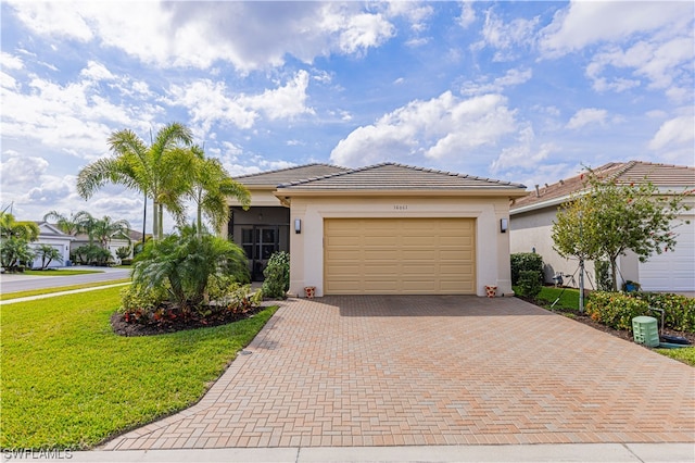 view of front of property with a garage and a front lawn