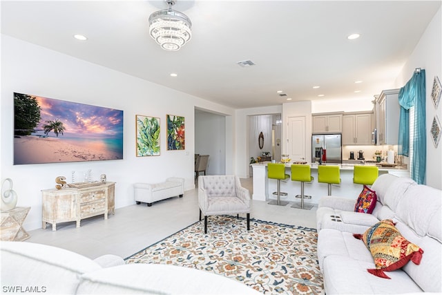 living room featuring a notable chandelier