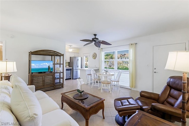 living room with ceiling fan and light tile patterned flooring