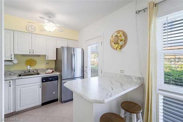 kitchen with kitchen peninsula, plenty of natural light, and stainless steel appliances