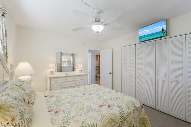 bedroom featuring light tile patterned floors, a closet, and ceiling fan