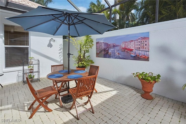 view of patio / terrace featuring a lanai