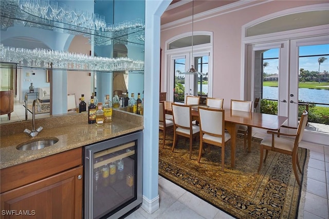 bar with wine cooler, french doors, indoor wet bar, crown molding, and a sink