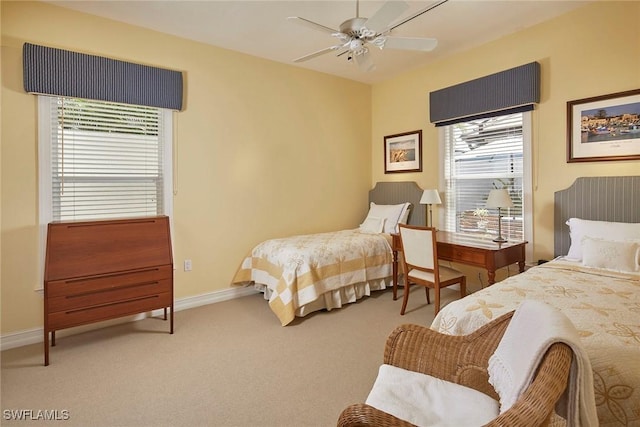 carpeted bedroom with baseboards and a ceiling fan