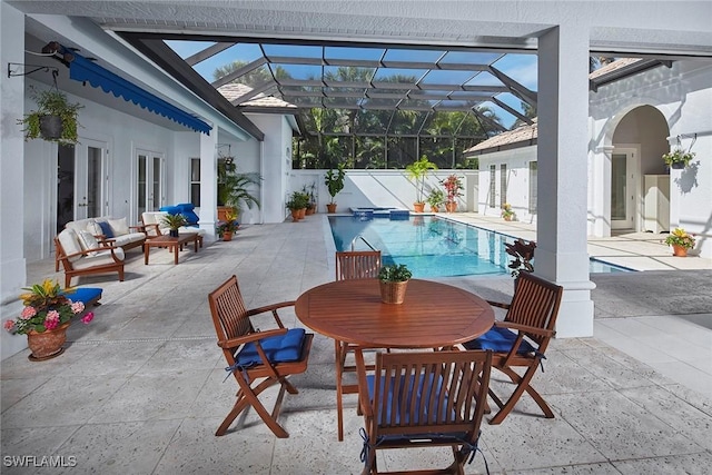 view of swimming pool with a lanai, a patio area, a fenced in pool, and french doors