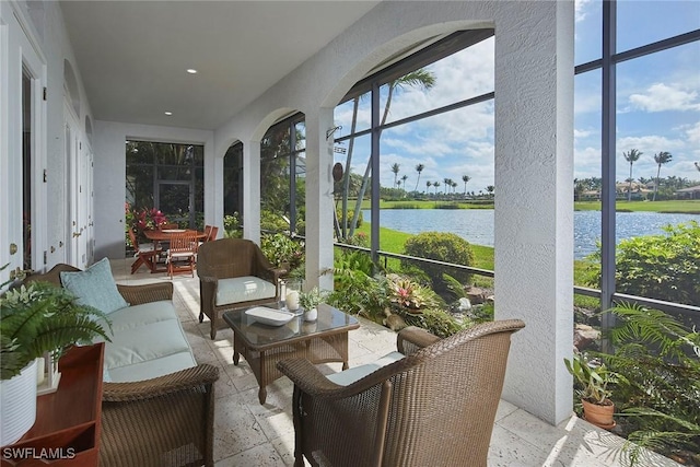 sunroom / solarium featuring a water view