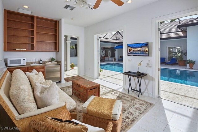 living area featuring visible vents, ceiling fan, rail lighting, light tile patterned flooring, and recessed lighting