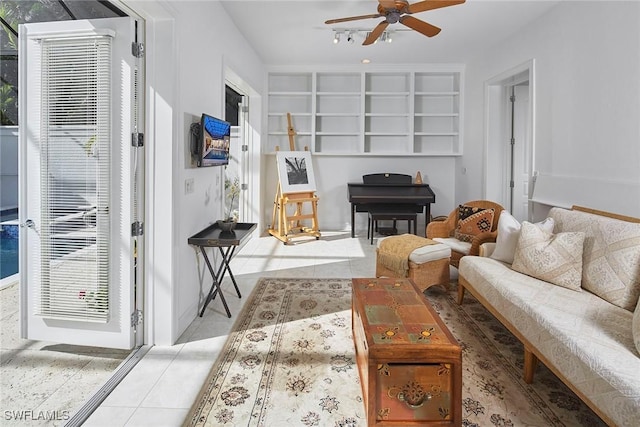 living area with ceiling fan, plenty of natural light, and tile patterned floors