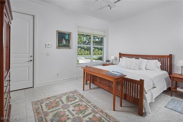 bedroom featuring light tile patterned floors, baseboards, and crown molding