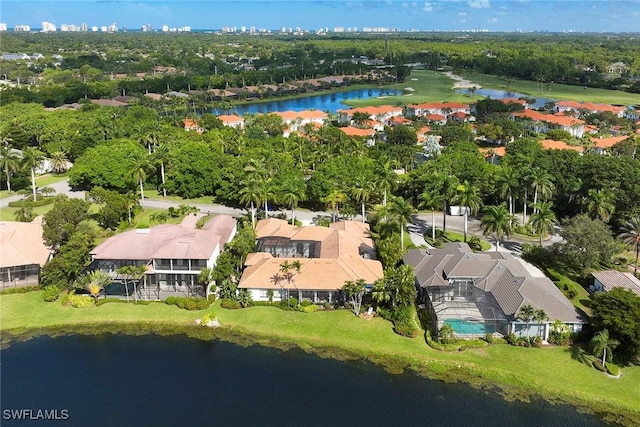 birds eye view of property with a water view and a residential view