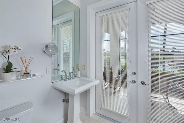 doorway to outside featuring baseboards and a wealth of natural light