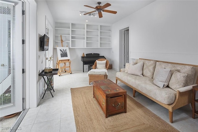living area featuring a ceiling fan, built in features, light tile patterned floors, and a heating unit
