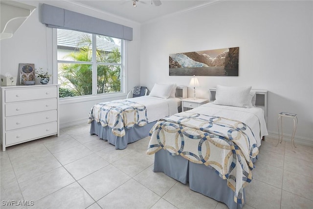 bedroom featuring light tile patterned flooring and baseboards