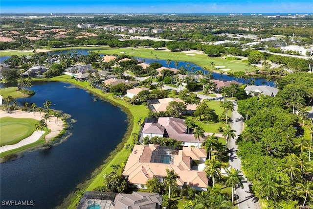 drone / aerial view with a residential view, view of golf course, and a water view