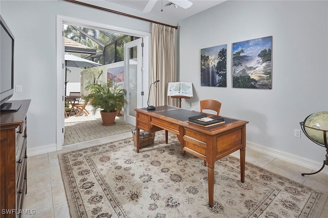 office featuring baseboards, a ceiling fan, and light tile patterned flooring